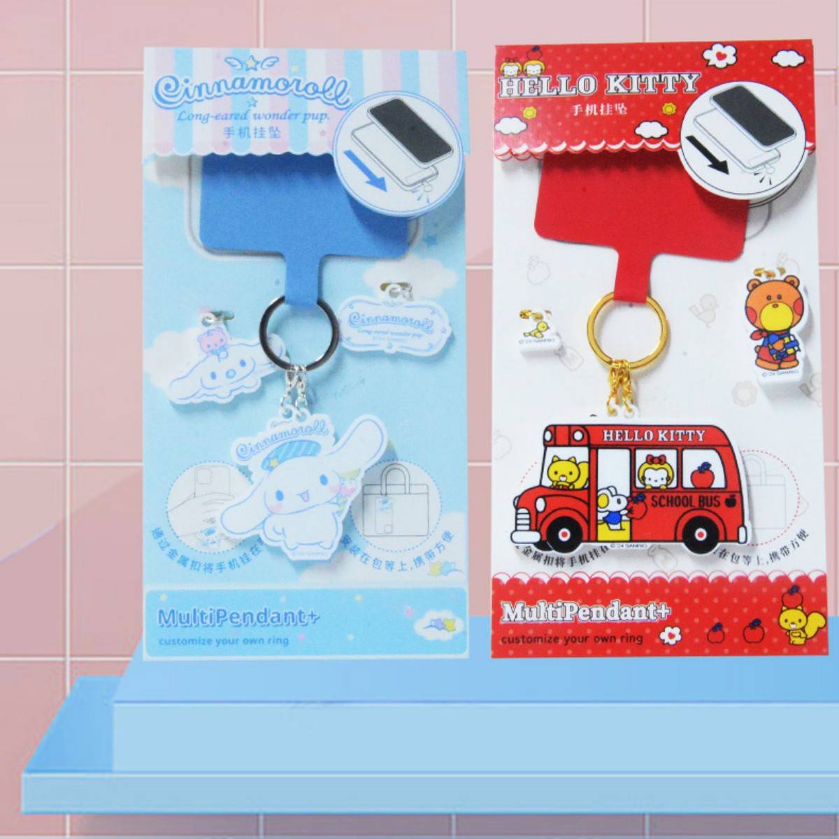 Cinnamoroll and Hello Kitty Sanrio Characters Phone Strap Keychains on a display stand. Cute and durable phone accessories for everyday use.