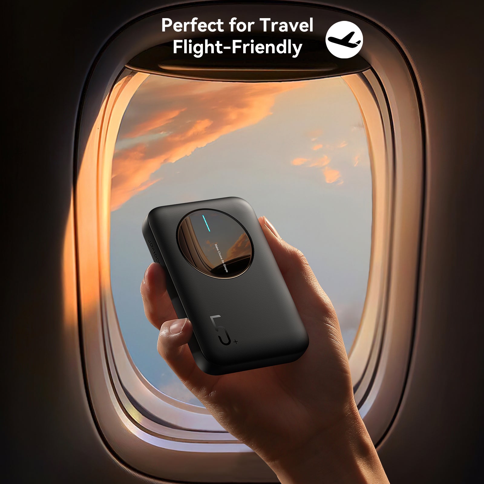 JOYROOM JR-PBF13 Mini Power Bank held in hand near airplane window, highlighting its flight-friendly and travel-ready design.