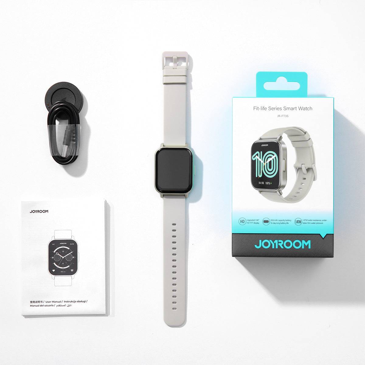 Unboxed white JOYROOM JR-FT3S Smart Watch with accessories including a charging cable and user manual. A complete smartwatch package for daily use.