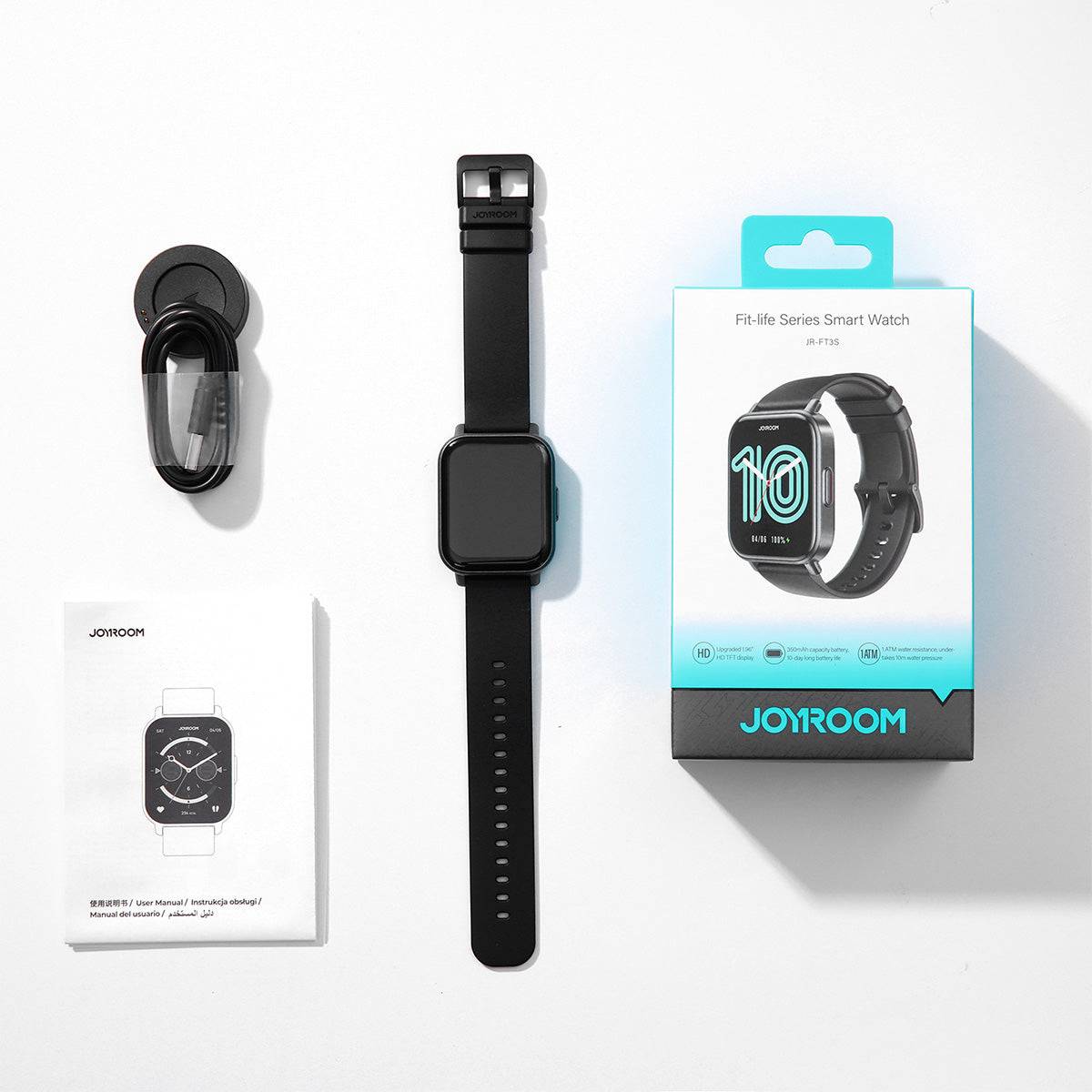 Unboxed JOYROOM JR-FT3S Smart Watch with accessories including a charging cable and user manual. A complete smartwatch package for daily use.