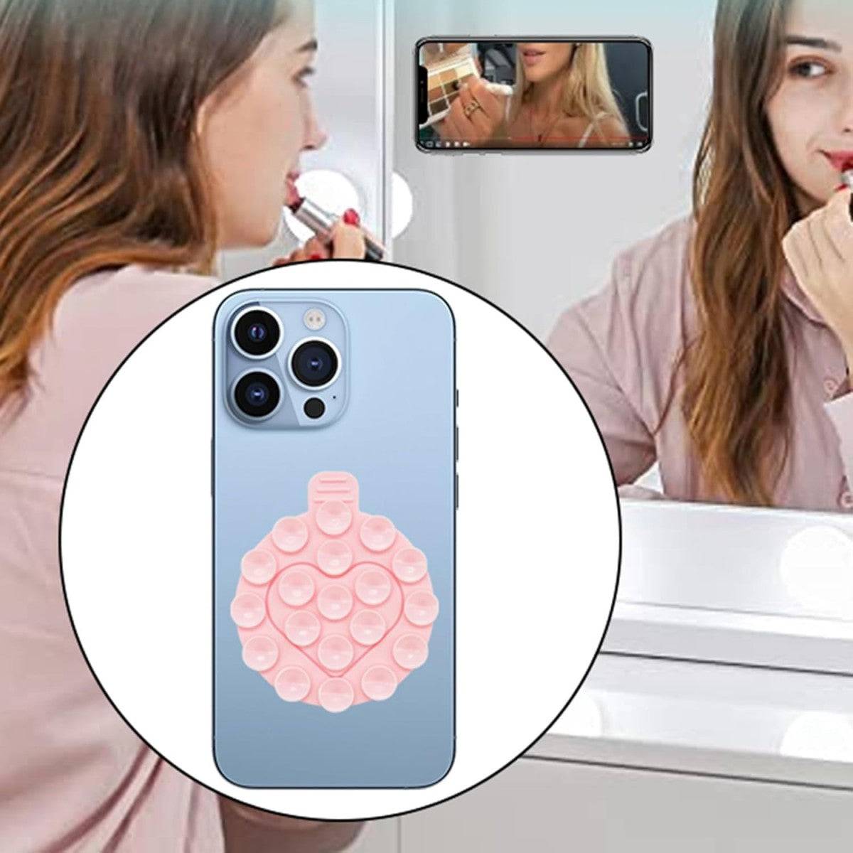 Light pink heart-shaped silicone suction cup phone holder attached to a smartphone, used for hands-free makeup application.