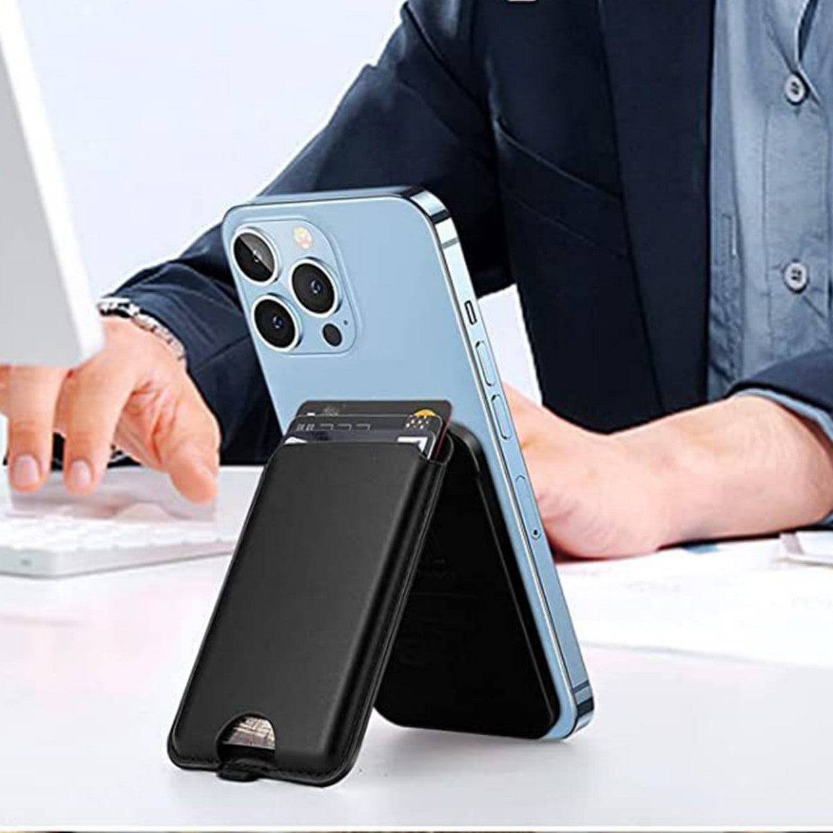Black leather magnetic wallet stand used as a phone stand on a desk, holding a smartphone upright. Ideal for hands-free viewing and card storage.