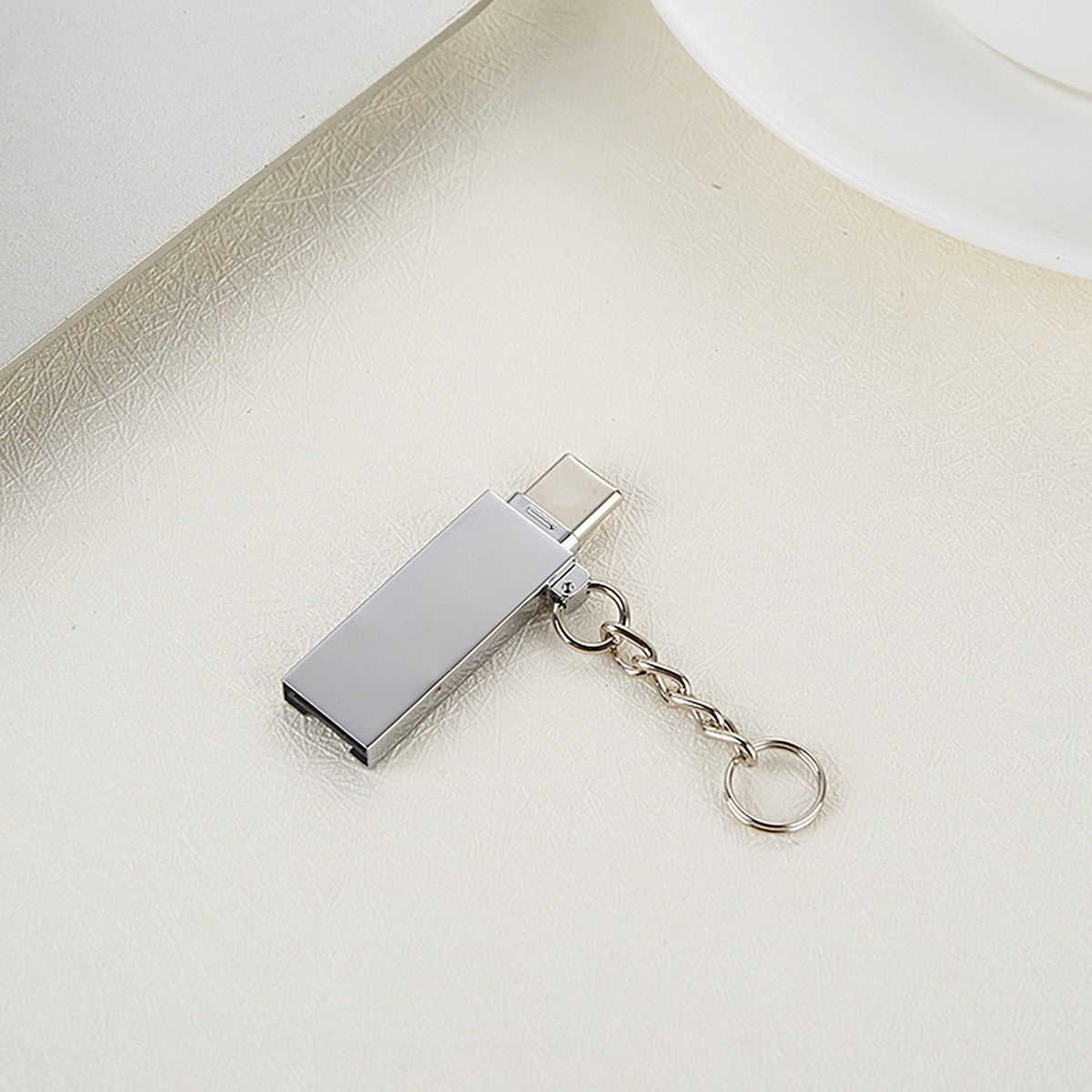 FT-ADA21 2-in-1 Card Reader for Type-C & USB A placed on a desk, showcasing its minimalist and portable design with keychain | Hugmie