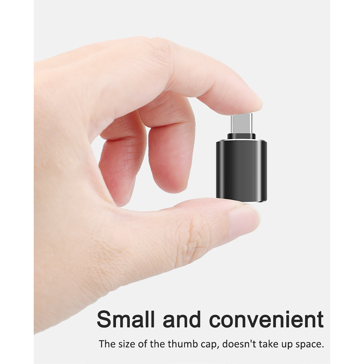FT-ADA27 Type-C to USB Adapter shown between fingers, highlighting its small, thumb-sized, and portable design.