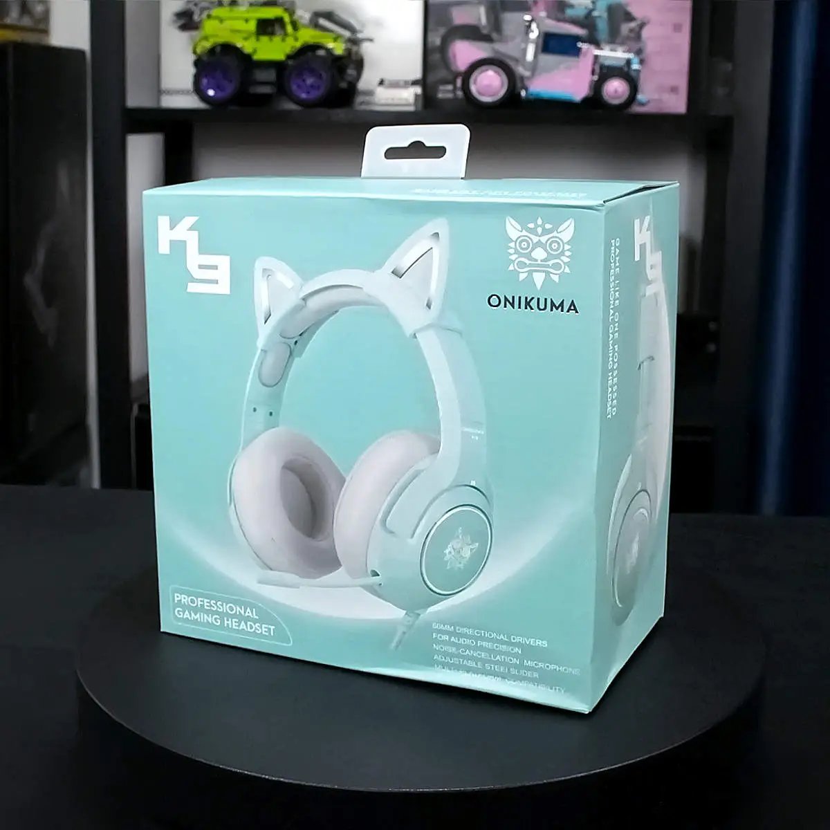 Retail packaging of the mint green ONIKUMA K9 Elite Gaming Headset, highlighting its stylish design, immersive sound, and multi-platform compatibility.