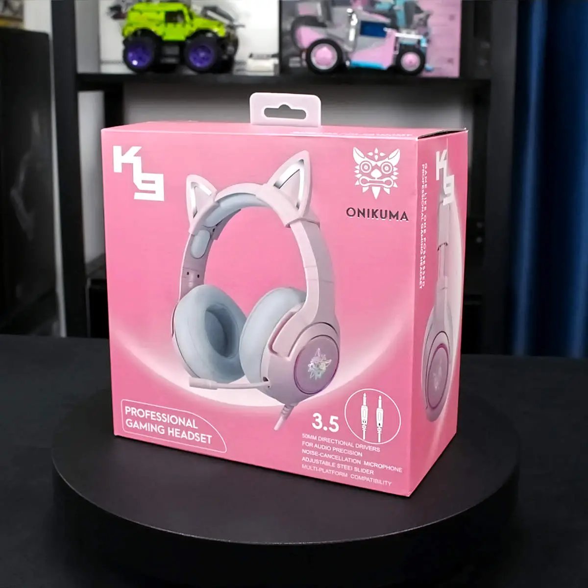 Retail packaging of the pink ONIKUMA K9 Elite Gaming Headset, featuring cat ears, 3.5mm connectivity, and professional gaming audio performance.