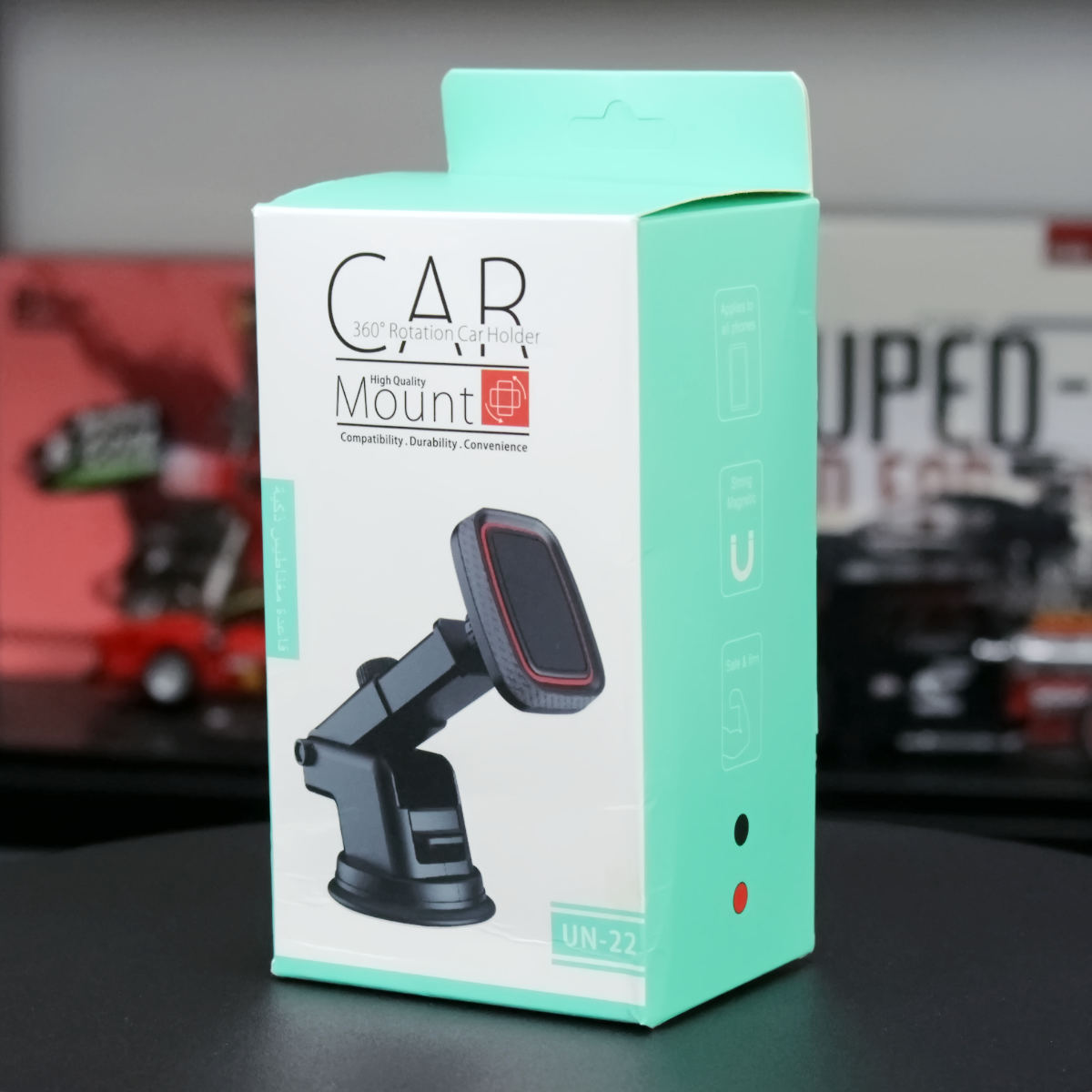 Retail packaging of the UN-22 Magnetic Car Phone Holder, showcasing product features and design.