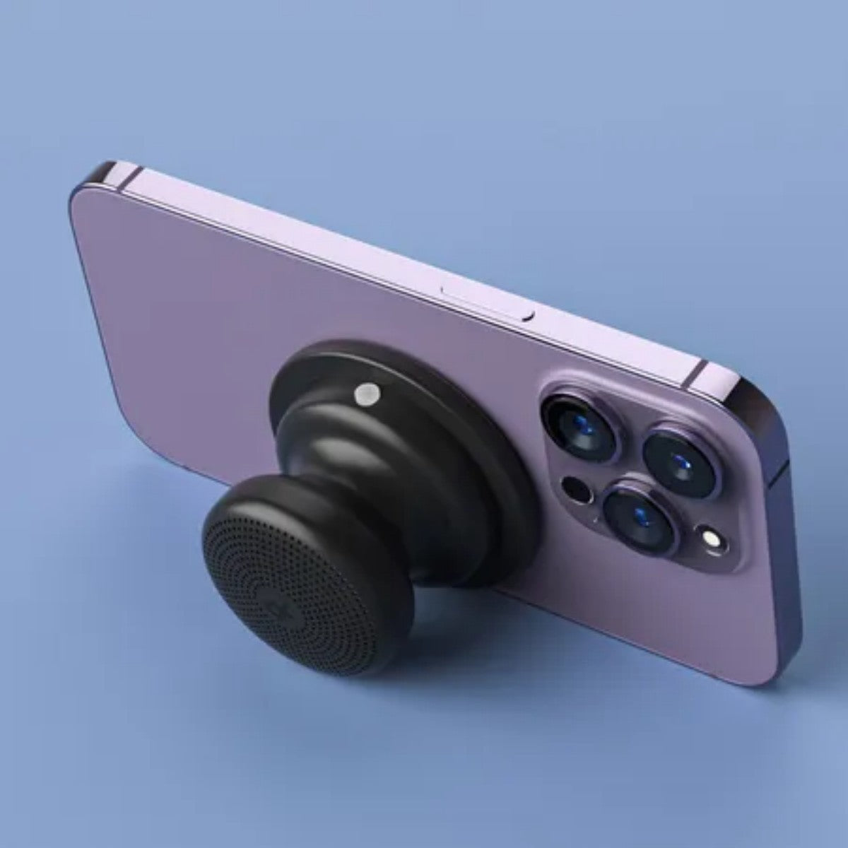Black EWA A117 Portable Mini Bluetooth Speaker mounted on the back of a purple smartphone, doubling as a phone holder.