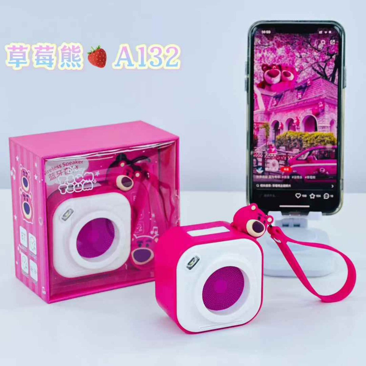 Pink A132 Cute Cartoon Mini Wireless Bluetooth Speaker displayed with packaging and phone, showcasing its fun design and Bluetooth connectivity.