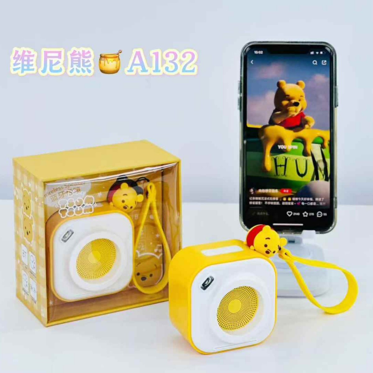 Yellow A132 Cute Cartoon Mini Wireless Bluetooth Speaker shown with retail packaging and smartphone, highlighting its compact audio performance.
