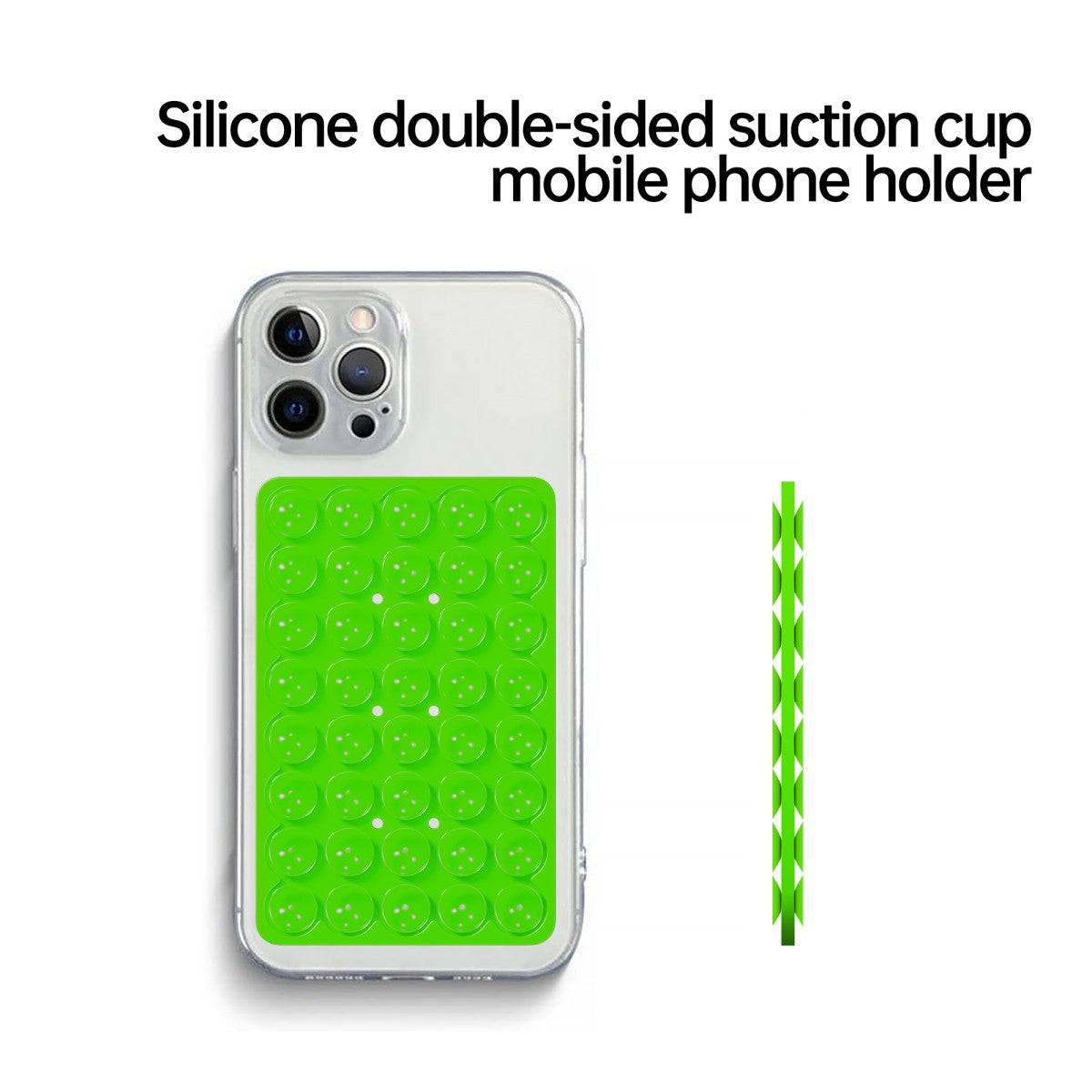 Green silicone double-sided suction cup phone holder attached to a smartphone. Reusable and ideal for hands-free use.
