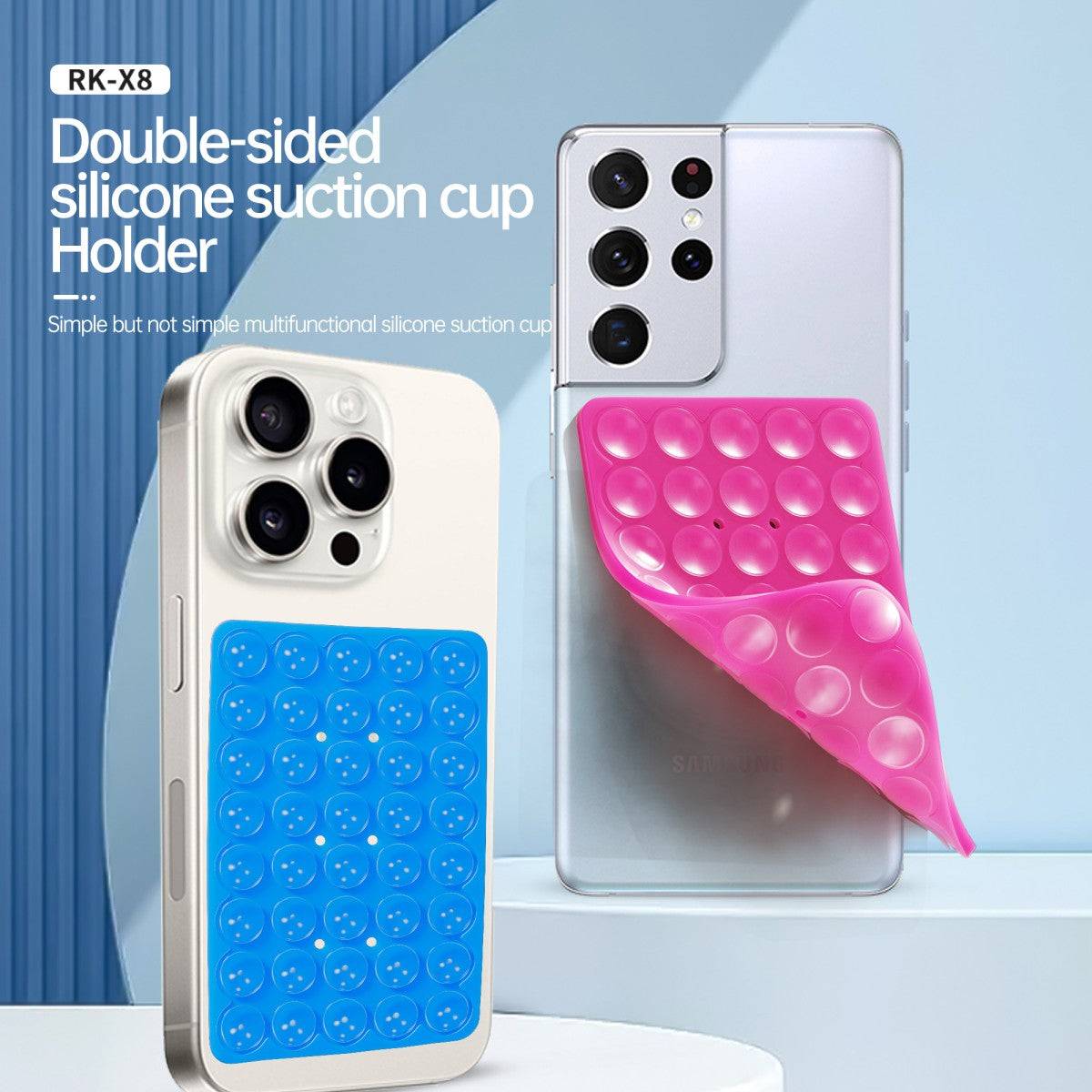 Double-sided silicone suction cup phone holder in blue and pink attached to smartphones. Strong adhesion for hands-free convenience.