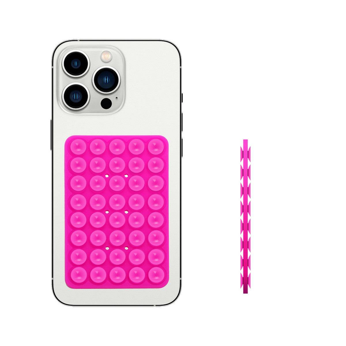 Pink double-sided silicone suction cup phone holder attached to a smartphone, providing hands-free convenience.