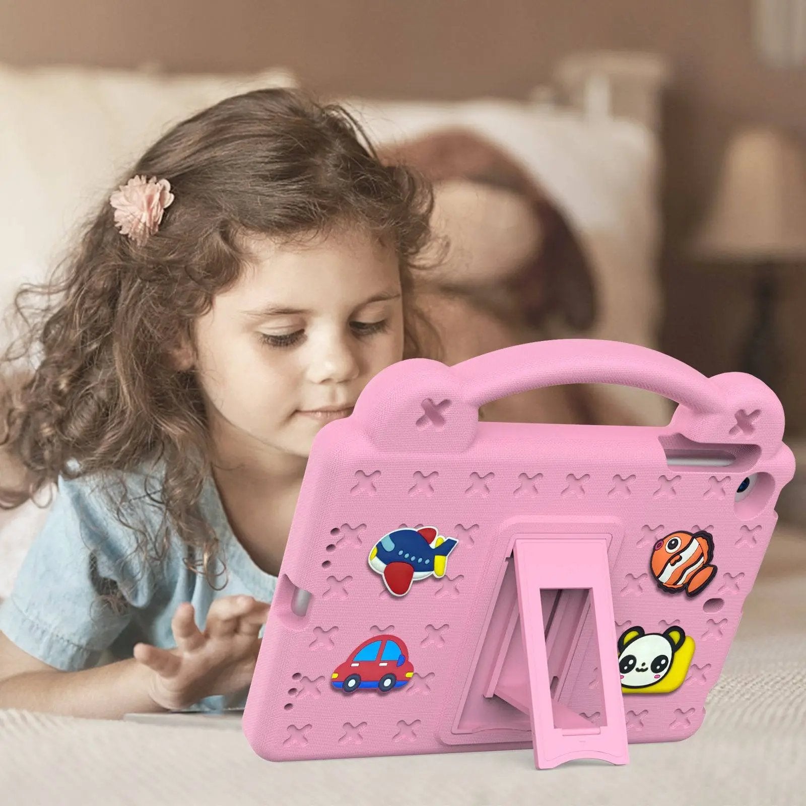 Young girl using a pink Handle Kids iPad Protective Case for Mini 1/2/3/4/5, featuring a sturdy stand and fun cartoon decorations for safe use.