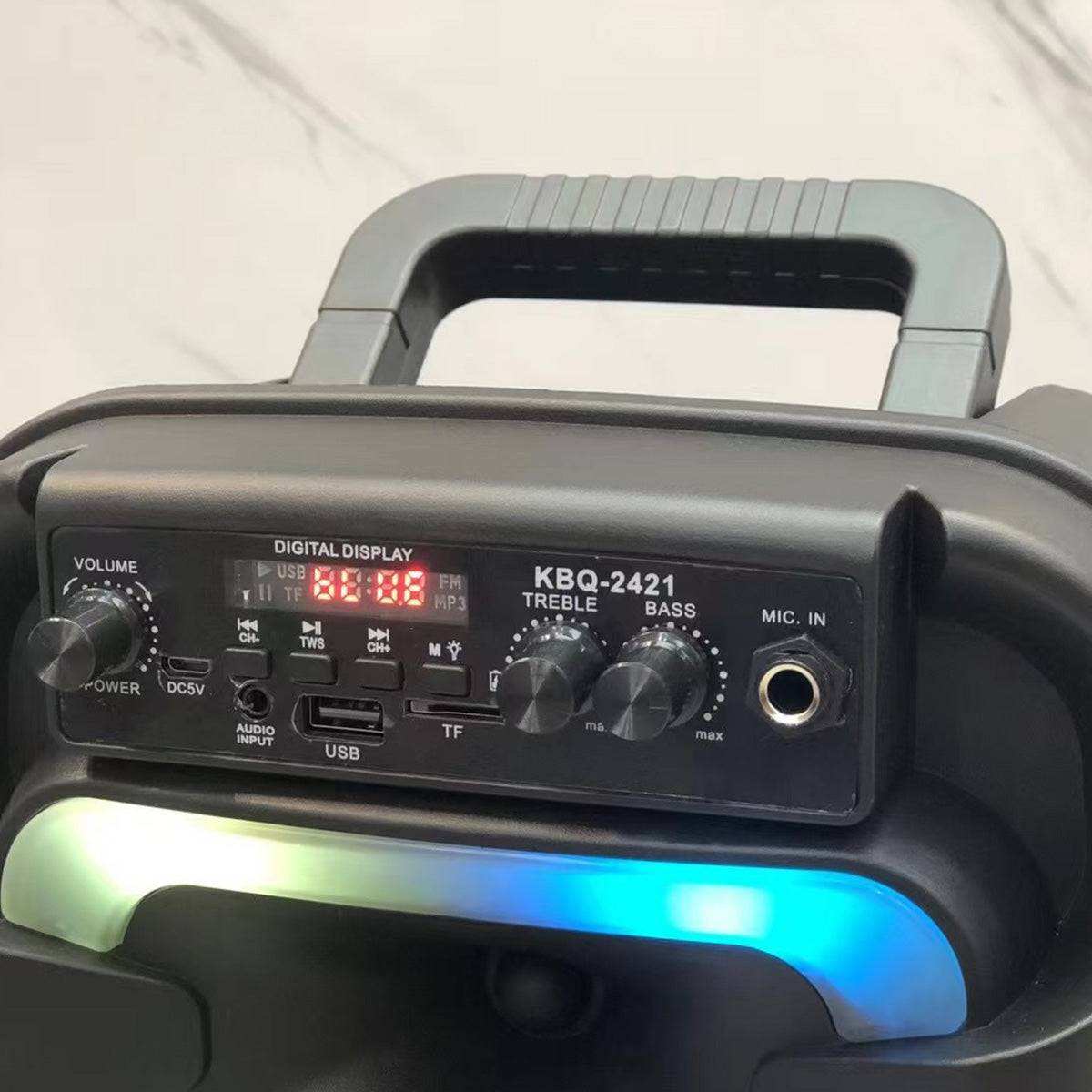Close-up of the KBQ-2421 Outdoor Bluetooth Karaoke Speaker's control panel with volume, bass, treble knobs, USB, TF card slots, and a digital display.