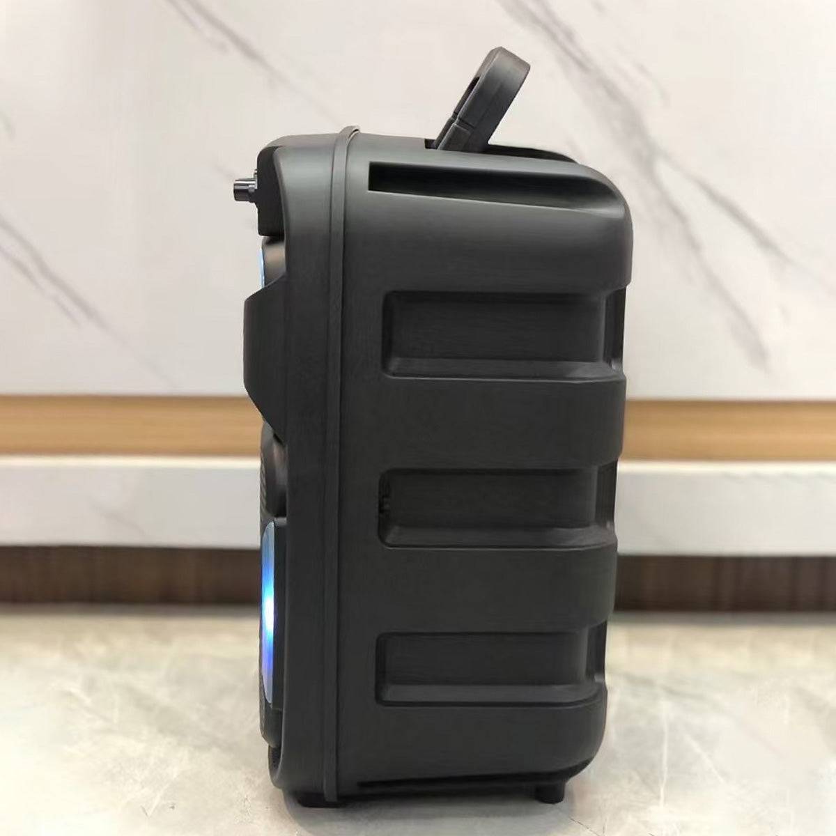Side profile of the KBQ-2421 Outdoor Bluetooth Karaoke Speaker, highlighting its rugged build, ergonomic handle, and LED-lit front panel.