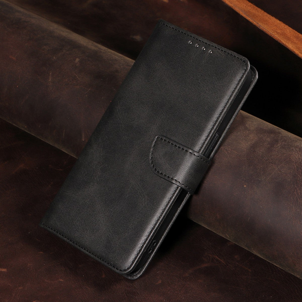 Closed black MatteCase Series iPhone Leather Case displayed on leather surface, highlighting its sleek and professional design.
