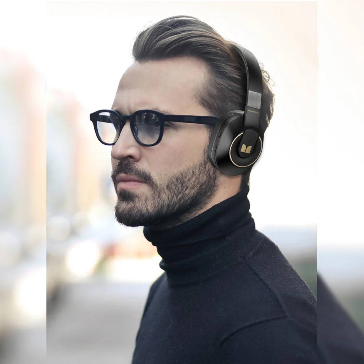 Man wearing MONSTER XKH01 Bluetooth Wireless Headphones in black, showcasing stylish design, ergonomic comfort, and premium sound quality.