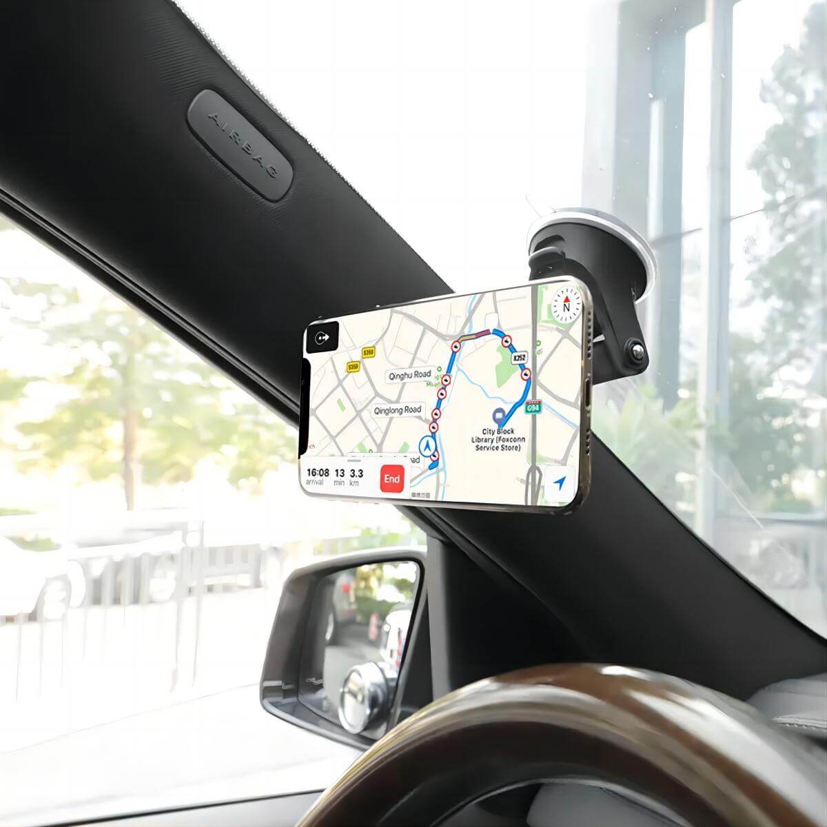 UN-22 Magnetic Car Phone Holder mounted on a windshield, holding a smartphone displaying navigation.